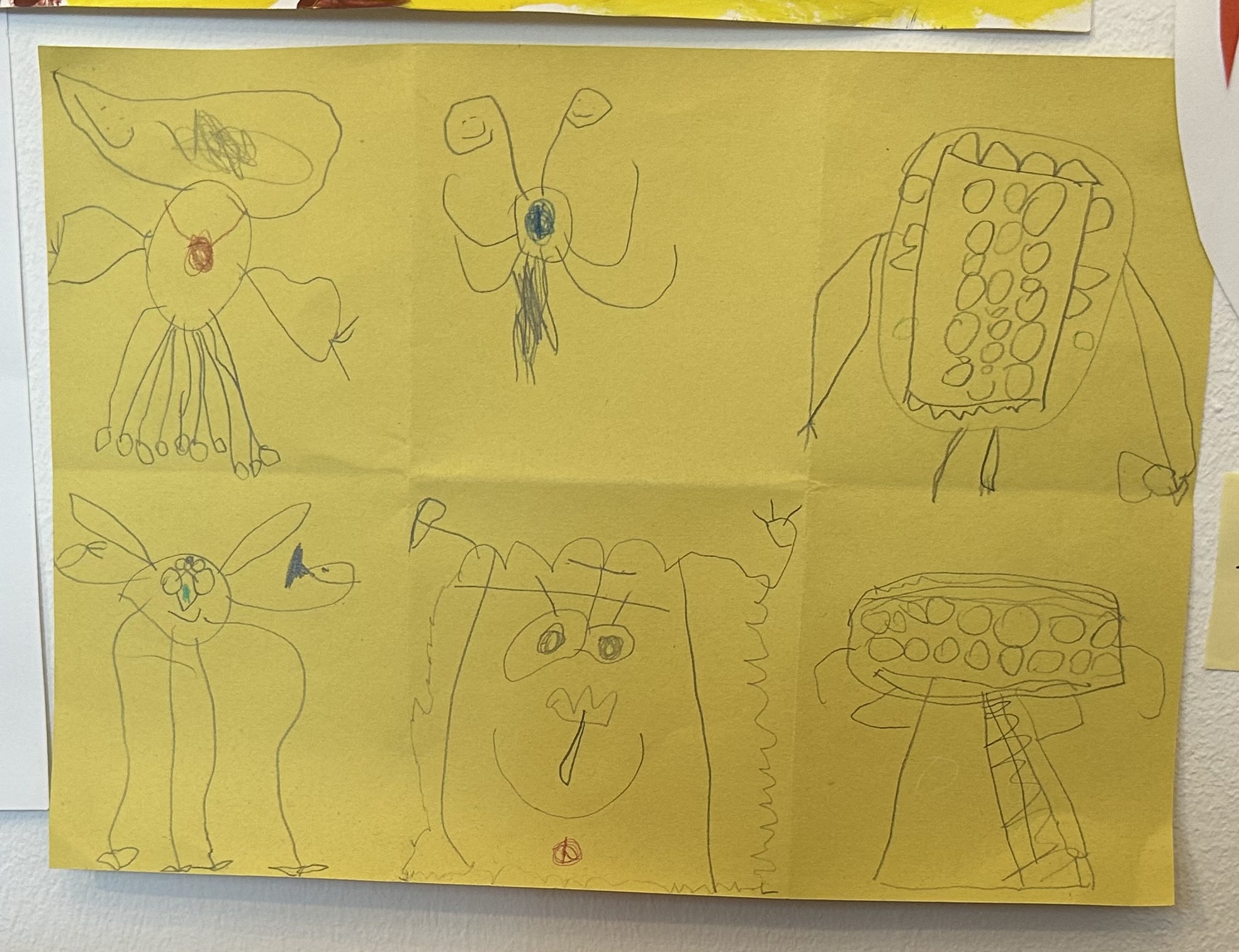stencil drawings on yellow folded paper divided into 6 part to represent 6 different creatures made by a child