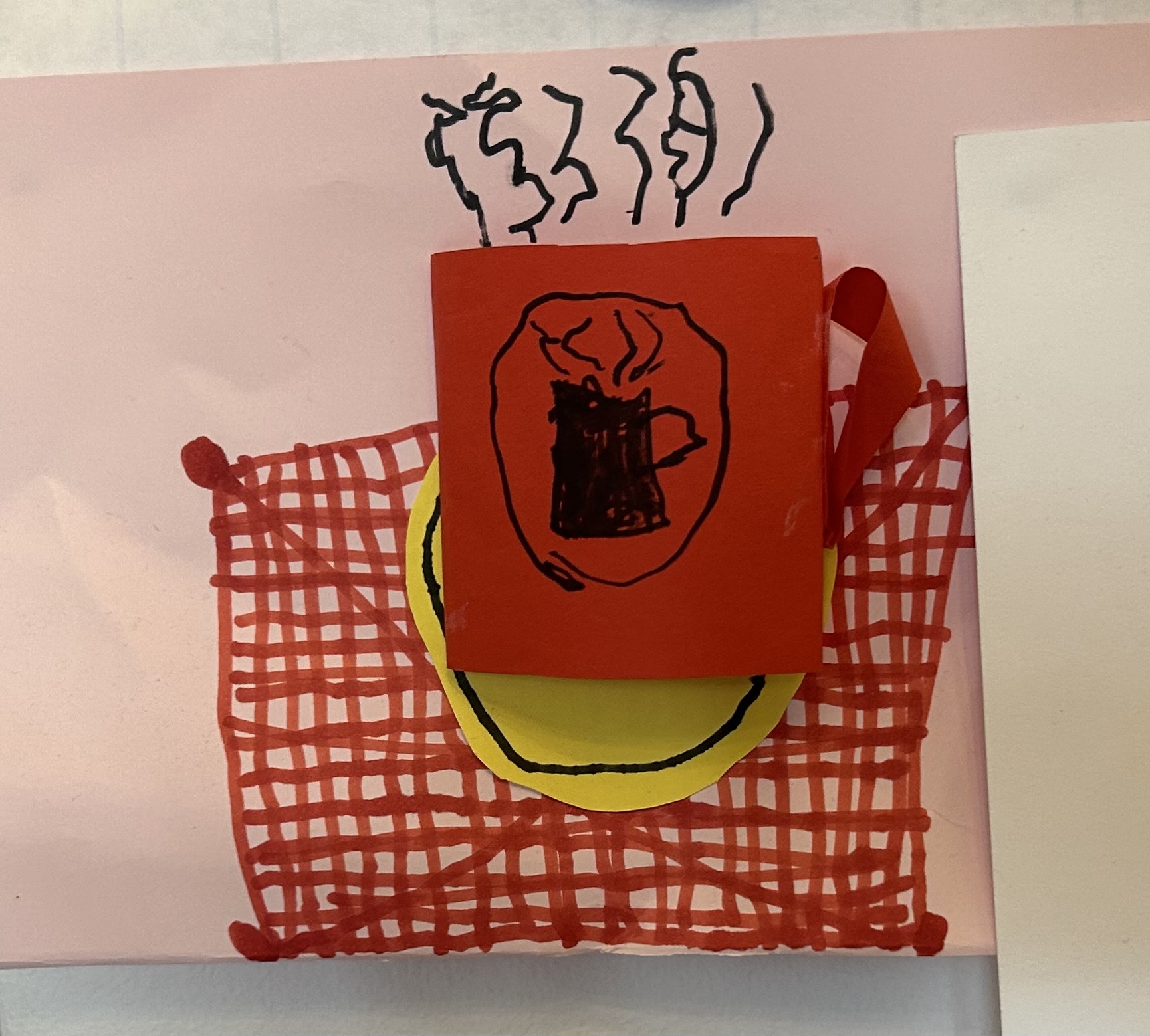 a mixed media coffee mug, layer paper glued onto paper both cut out to be a steaming coffee mug, and having another steaming coffee mug drawn on it, made by a child